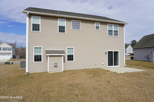 rear view of house with a patio area, cooling unit, and a lawn