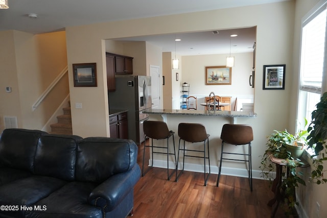 living room with visible vents, recessed lighting, stairway, and dark wood-style flooring