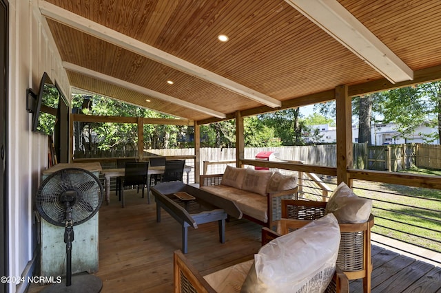 sunroom featuring lofted ceiling with beams and wood ceiling