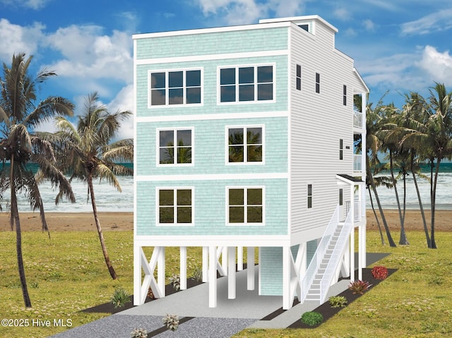 exterior space with a balcony, stairway, gravel driveway, a front yard, and a carport