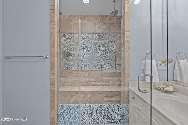 bathroom featuring a stall shower and vanity