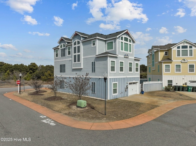 view of front of property with an attached garage, board and batten siding, and driveway