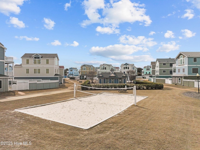 view of home's community with fence, a residential view, and volleyball court