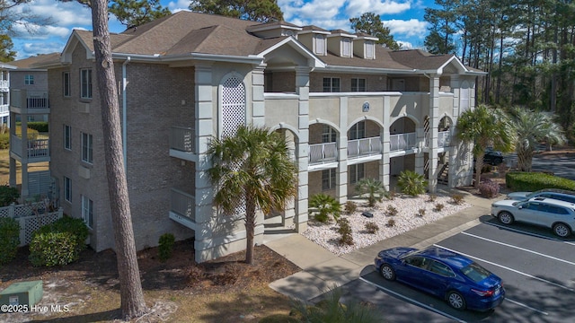 view of building exterior featuring uncovered parking