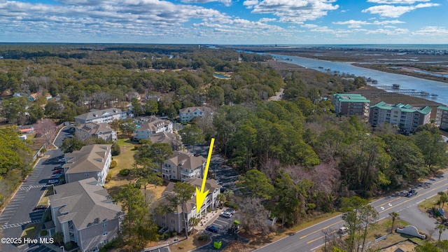 birds eye view of property with a water view and a view of trees