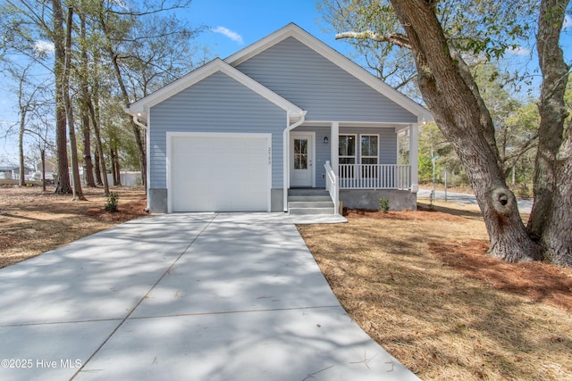 view of front facade with covered porch, driveway, and an attached garage