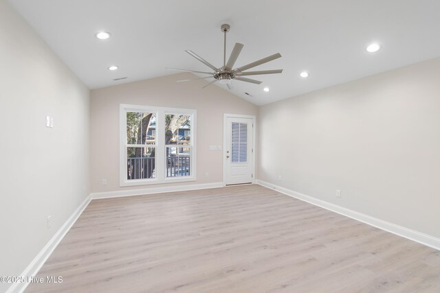 kitchen featuring white cabinets, light stone counters, stainless steel appliances, and a sink