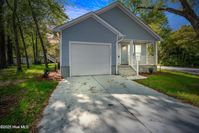 view of front of home with an attached garage, concrete driveway, and covered porch