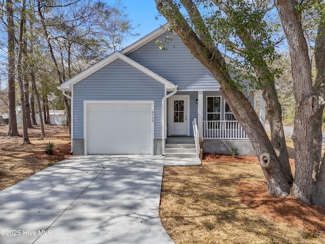 view of front of house with a porch, concrete driveway, and an attached garage