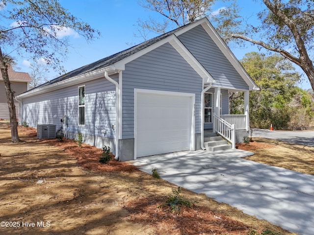 view of home's exterior with a porch, an attached garage, driveway, and central AC