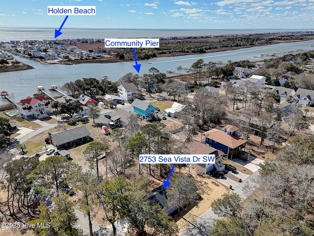 birds eye view of property with a residential view and a water view
