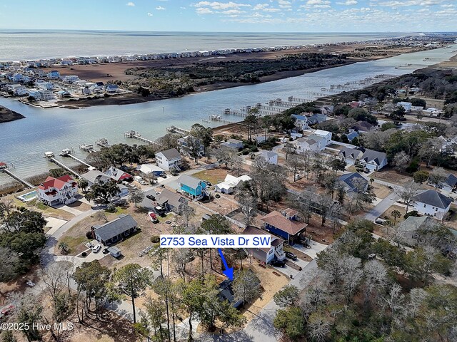 bird's eye view featuring a water view and a residential view