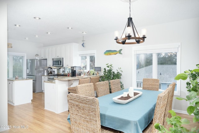 dining area with recessed lighting, a chandelier, and light wood finished floors