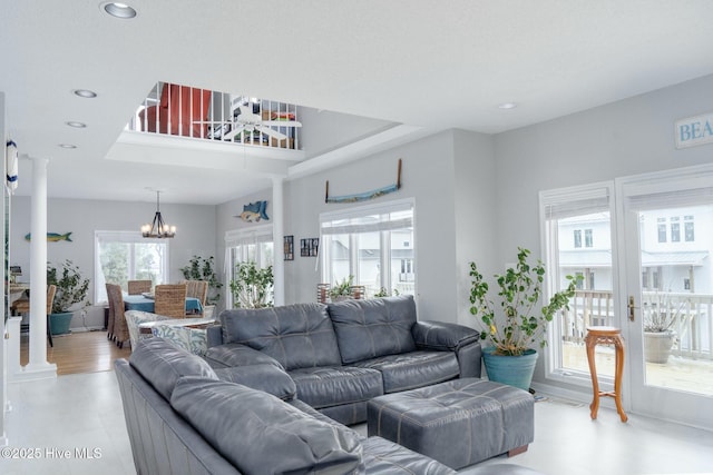 living room featuring recessed lighting, french doors, and a notable chandelier