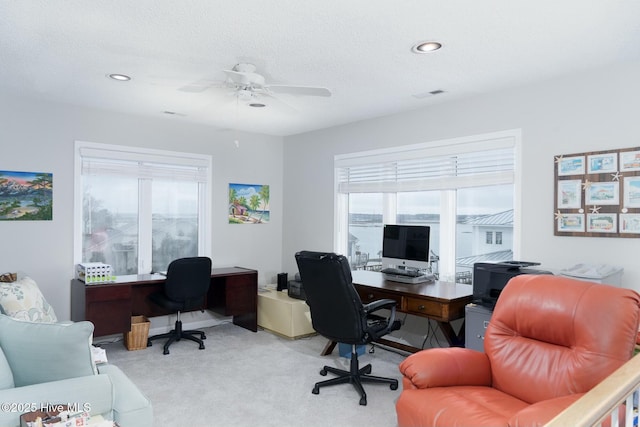 carpeted office with recessed lighting, visible vents, a healthy amount of sunlight, and a textured ceiling