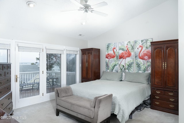 bedroom with access to exterior, visible vents, light colored carpet, vaulted ceiling, and a ceiling fan