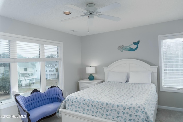 bedroom with multiple windows, visible vents, baseboards, and carpet floors