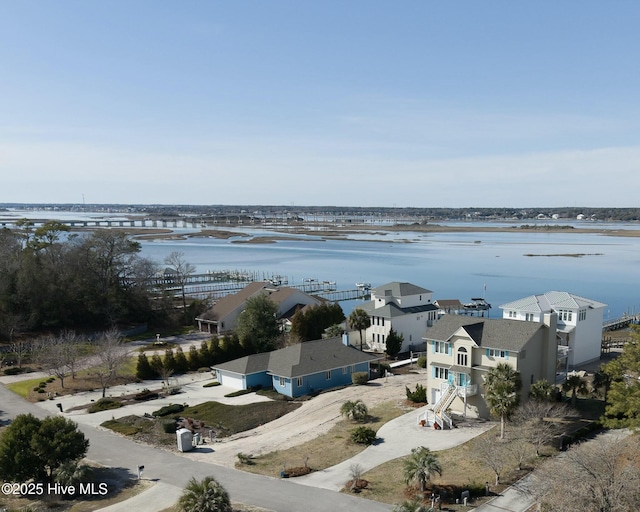 drone / aerial view featuring a water view and a residential view