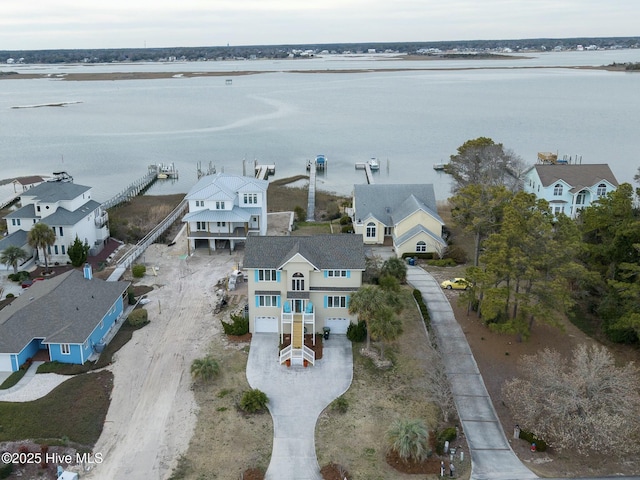 drone / aerial view with a residential view and a water view