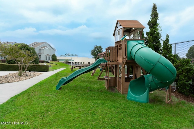 view of play area featuring a lawn and fence