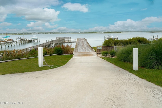 exterior space with a water view and a dock