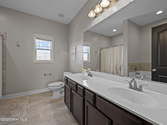 full bathroom featuring a sink, visible vents, baseboards, and toilet