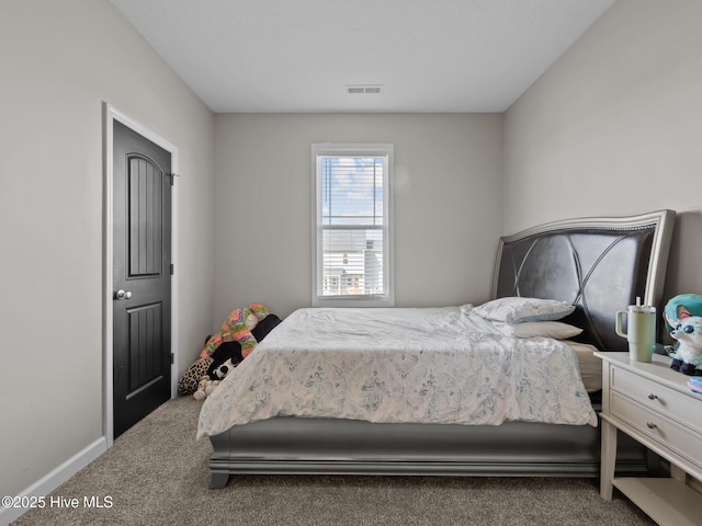 carpeted bedroom with visible vents and baseboards