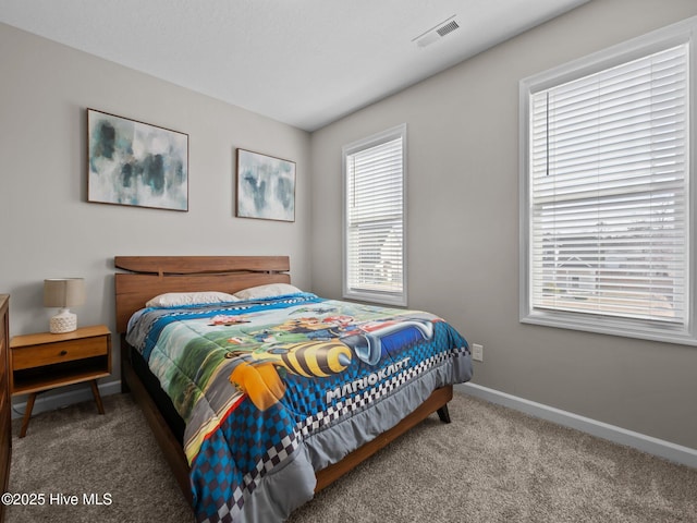 carpeted bedroom with baseboards and visible vents