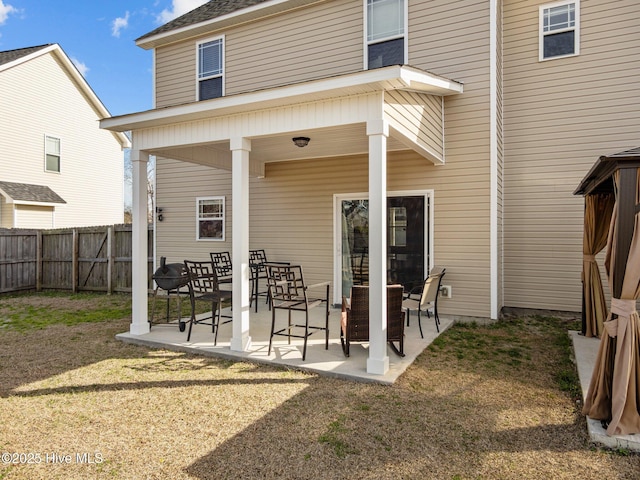 back of property featuring a patio area, a yard, and fence