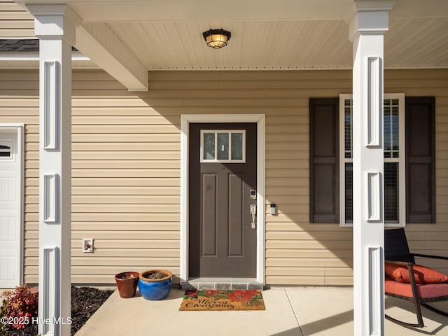 view of exterior entry with a porch