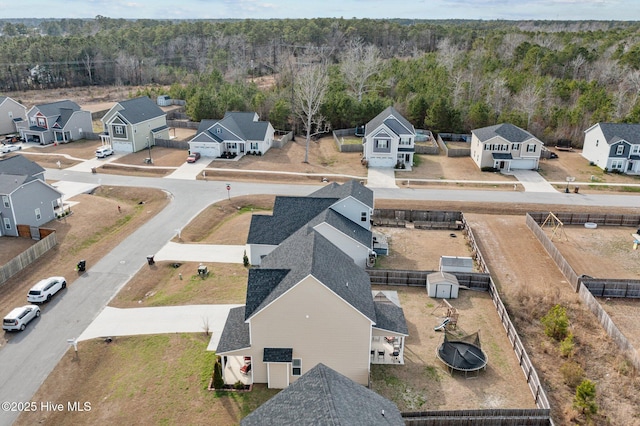 aerial view featuring a view of trees and a residential view