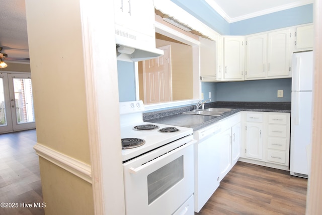 kitchen with white appliances, a sink, under cabinet range hood, white cabinetry, and crown molding