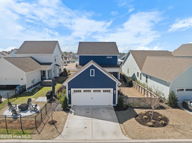 traditional-style house with a residential view, fence private yard, a garage, and driveway