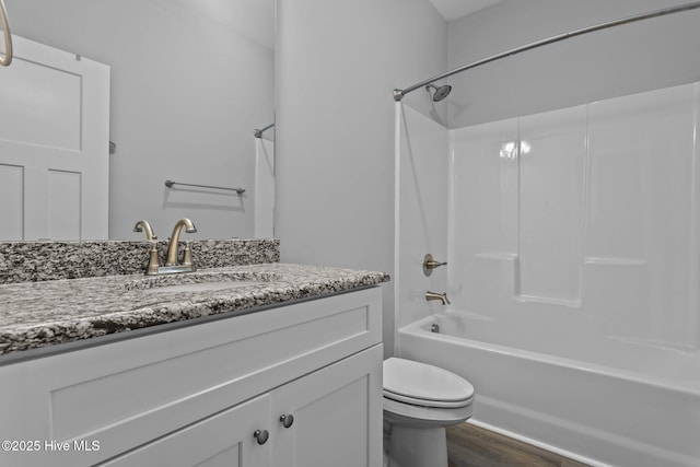 full bathroom featuring shower / bathing tub combination, toilet, wood finished floors, and vanity