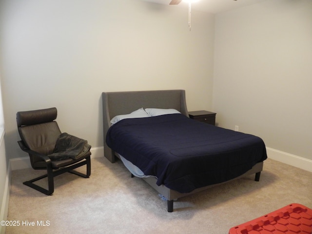 carpeted bedroom with baseboards and ceiling fan