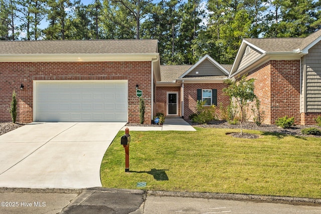 view of front of property featuring a front yard, an attached garage, brick siding, and driveway