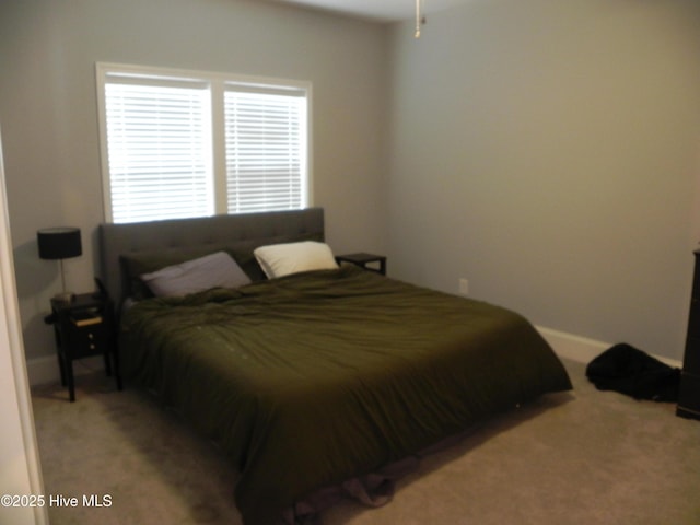 carpeted bedroom featuring baseboards