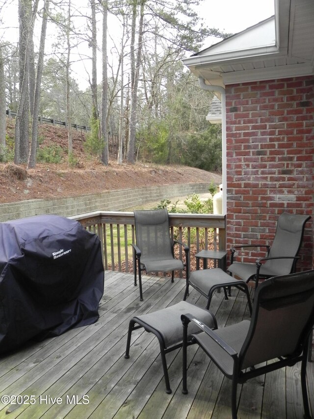 wooden deck with a grill