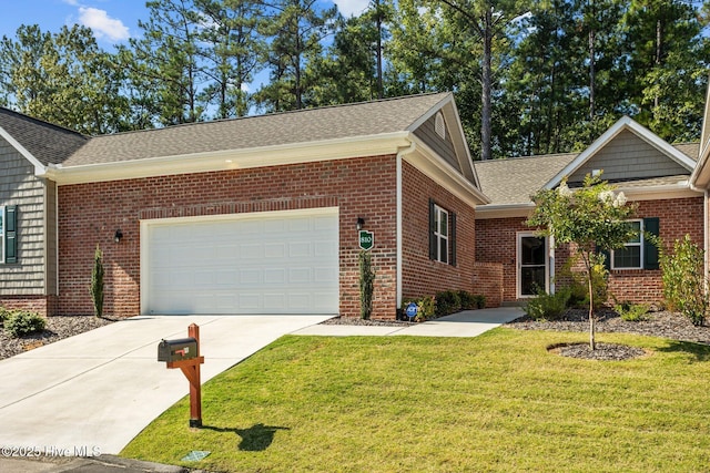 ranch-style home featuring roof with shingles, concrete driveway, a front yard, an attached garage, and brick siding