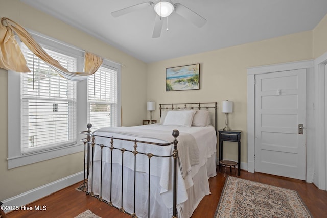 bedroom with wood finished floors, baseboards, and ceiling fan