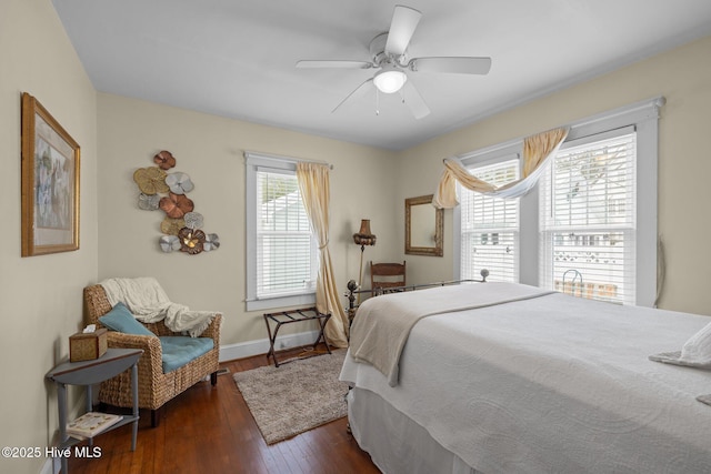 bedroom with dark wood finished floors, ceiling fan, and baseboards