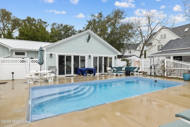 view of swimming pool with a fenced backyard, a fenced in pool, outdoor lounge area, and a patio