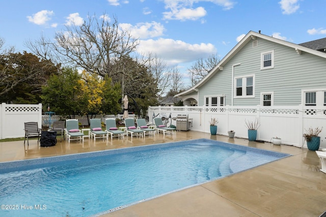 view of pool featuring a fenced in pool, a patio, a grill, and a fenced backyard