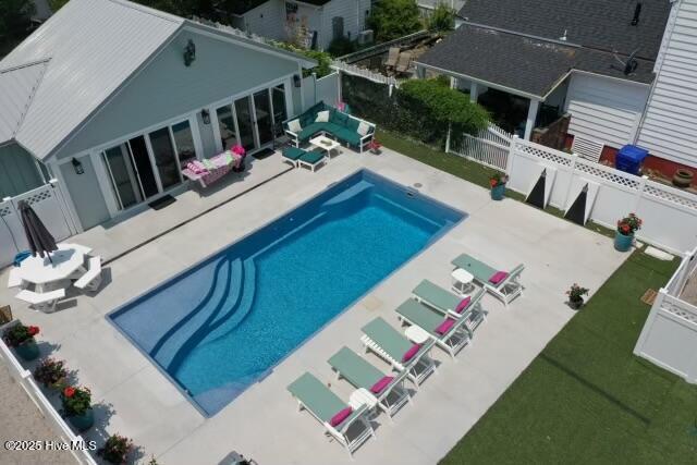 view of swimming pool with a fenced in pool, grilling area, a fenced backyard, and a patio area