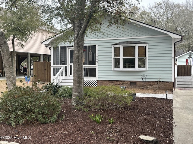 view of front of house with crawl space and a sunroom