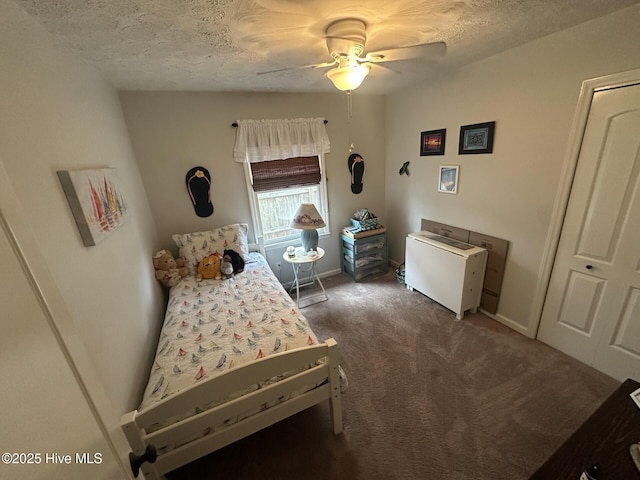 bedroom with carpet floors, baseboards, a ceiling fan, and a textured ceiling