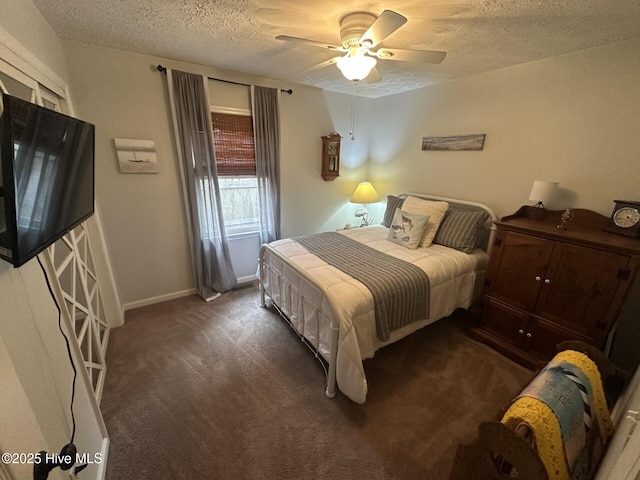 bedroom featuring a ceiling fan, carpet, a textured ceiling, and baseboards