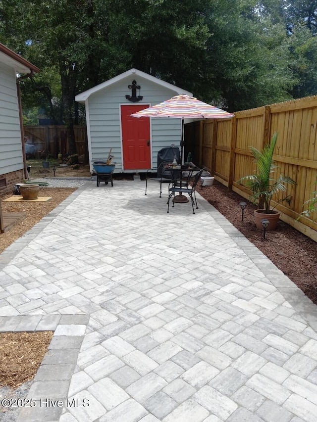 view of patio featuring a fenced backyard and an outbuilding