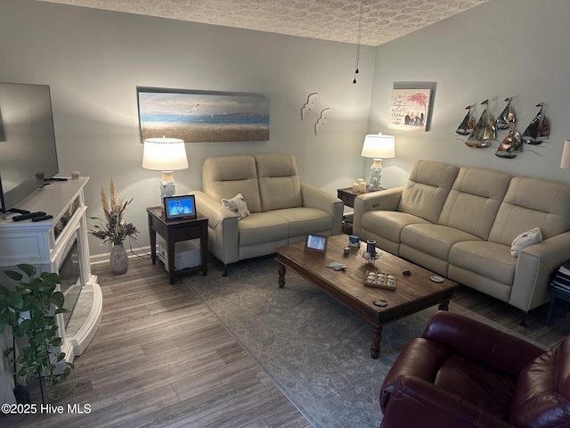 living room featuring wood finished floors and baseboards