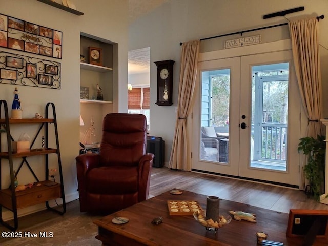 entryway featuring built in shelves, wood finished floors, and french doors